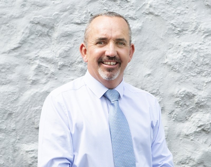 man smiling on grey background