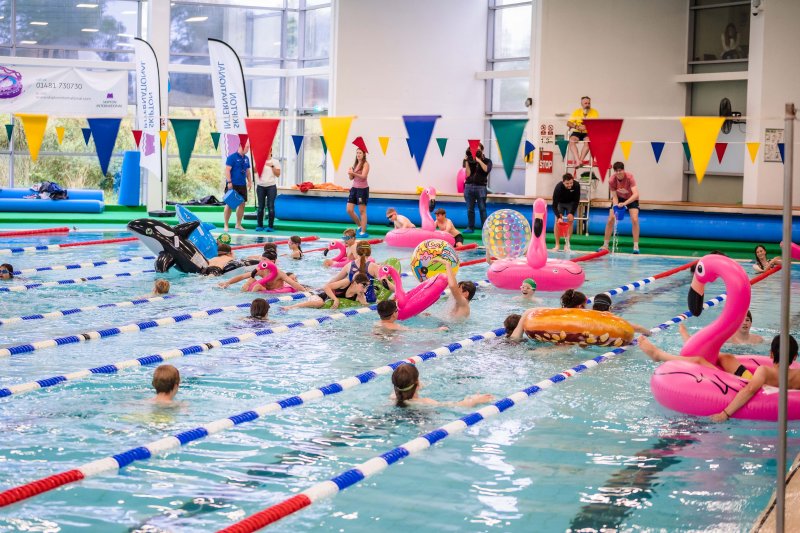 group of young children playing in swimming pool