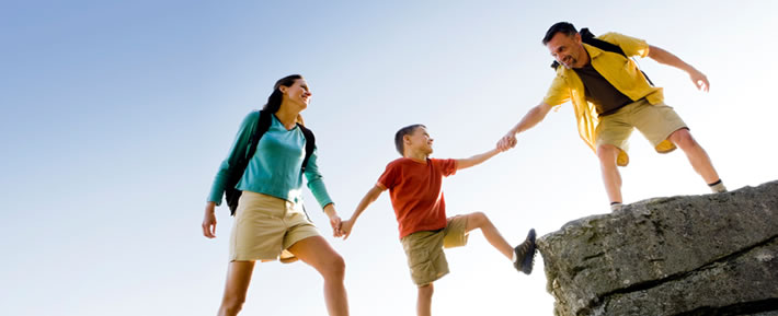 Family climbing onto rocks