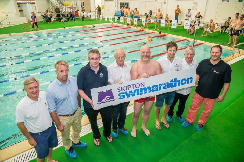People holding Swimarathon sign