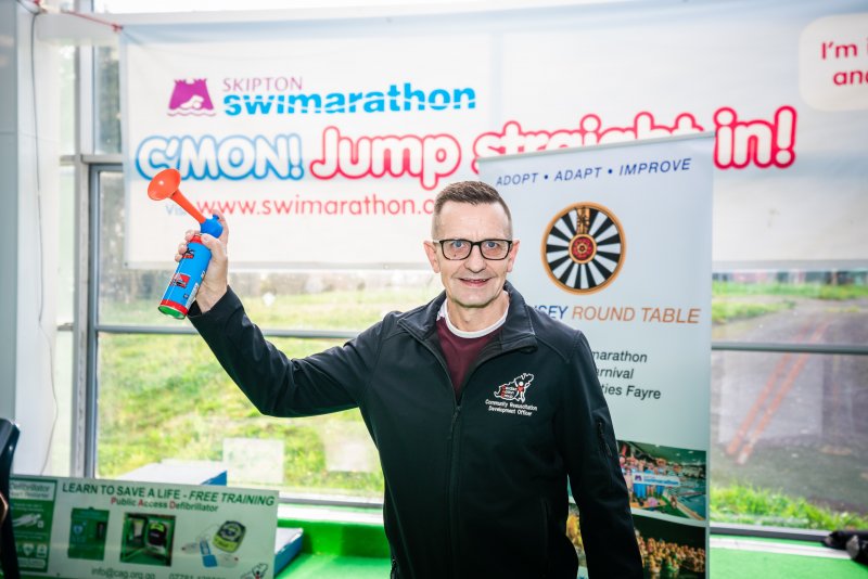 Skipton beneficiary holding air horn at Skipton Swimarathon