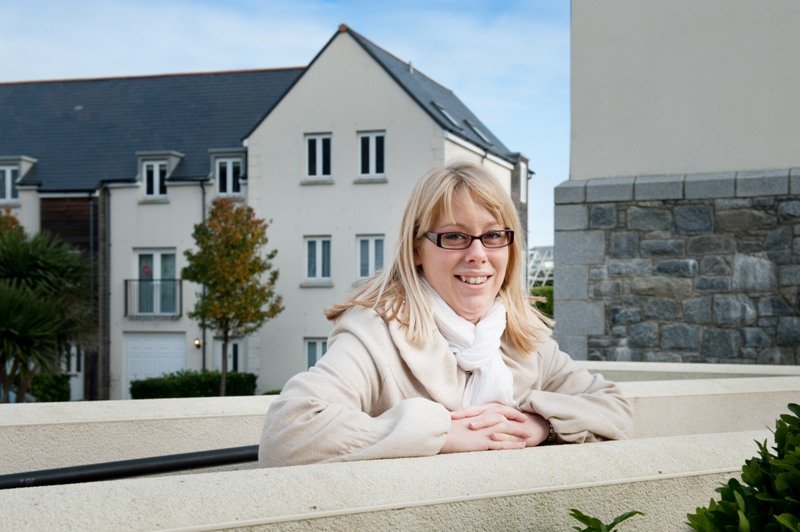 Happy lady in front of houses