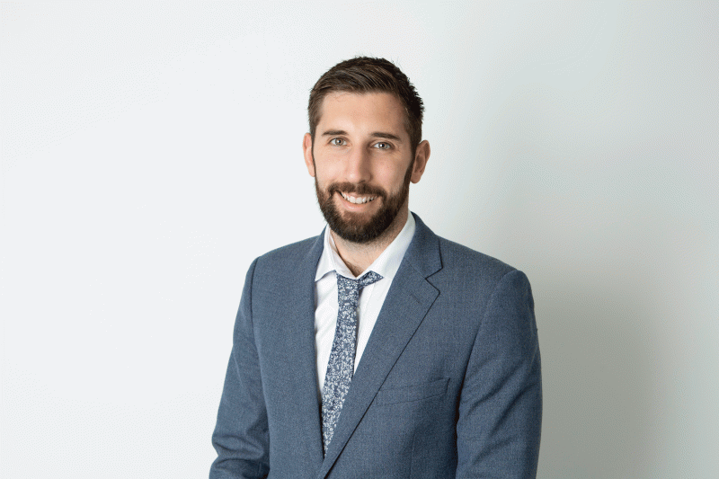 man smiling on grey background