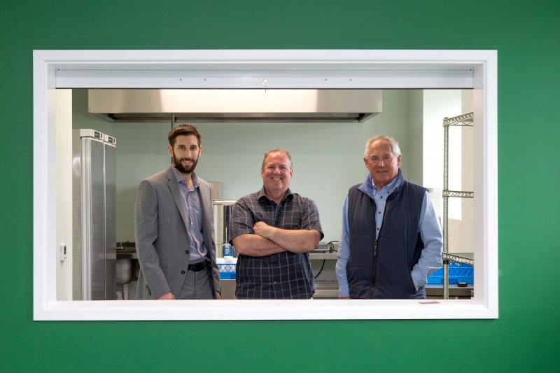 three men in canteen window